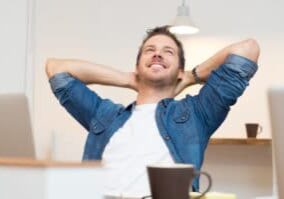 a happy young man relaxing after finding the right apartment
